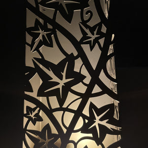 Decorative metal screen with star patterns on a black background